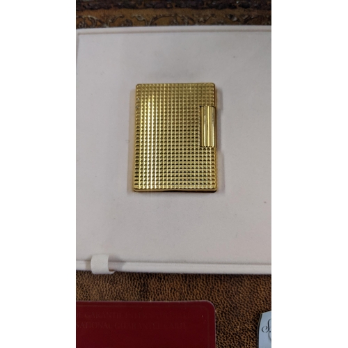 115 - A boxed gold plated DuPont lighter with embossed decoration engraved CH, 4cm x 5cm
Location: CAB
If ... 