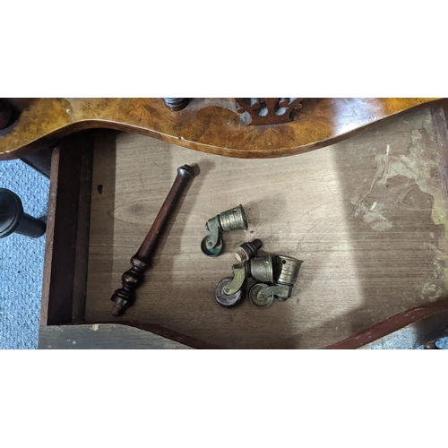 A Victorian walnut serpentine fronted Canterbury having a scroll cared