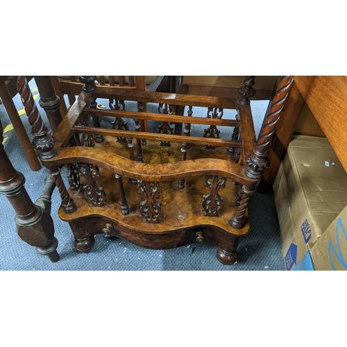 A Victorian walnut serpentine fronted Canterbury having a scroll cared