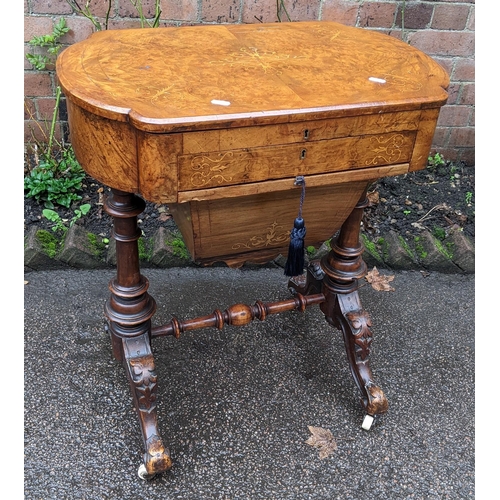 556 - A Victorian walnut work table having marquetry inlaid hinged top with a fitted interior and drawer b... 