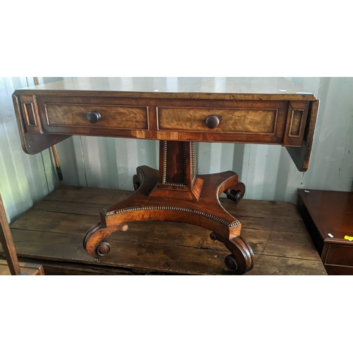 591 - A Regency mahogany sofa table having four drawers, square tapering column, quatrefoil base with scro... 