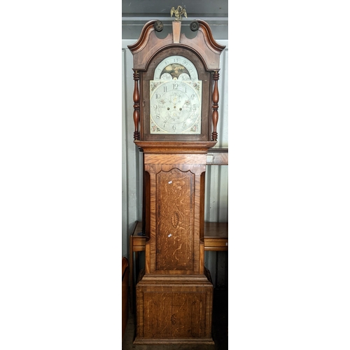 597 - A George III oak cased 8 day longcase clock having a broken swan neck pediment, arched dial and stri... 