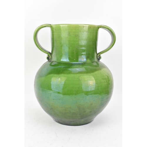 1 - An Arts & Crafts Liberty twin handled vase, having a green glaze, globular body, twin scroll handles... 