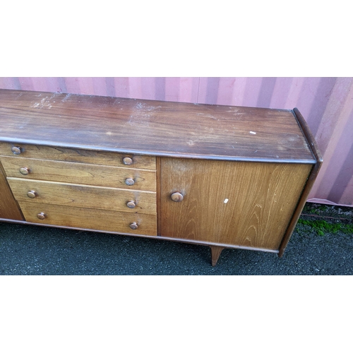 100 - John Herbert for A. Younger Ltd - A 1960s teak Volany sideboard, having a slightly curved top over f... 