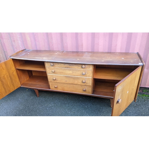 100 - John Herbert for A. Younger Ltd - A 1960s teak Volany sideboard, having a slightly curved top over f... 