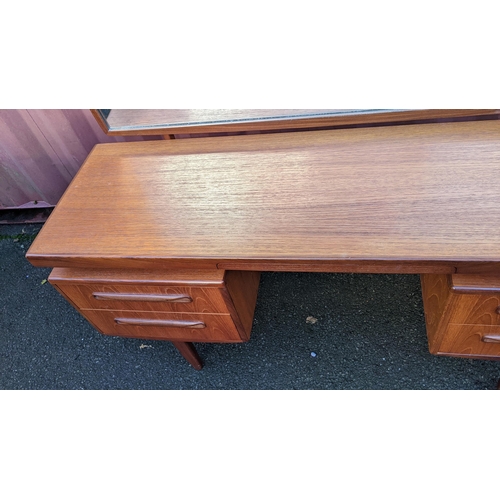 107 - A mid 20th century G-Plan Fresco range teak dressing table, designed by Victor B Wilkins, having a m... 