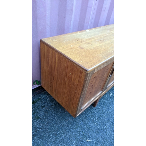 109 - A mid 20th century G-Plan Fresco range teak sideboard, designed by Victor B Wilkins, having four cen... 