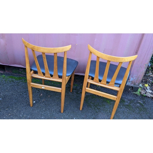 110 - A mid 20th century retro teak extending dining table together with six teak dining chairs, the table... 