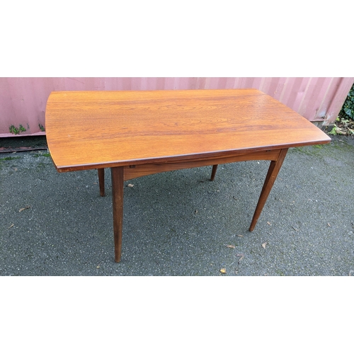 110 - A mid 20th century retro teak extending dining table together with six teak dining chairs, the table... 