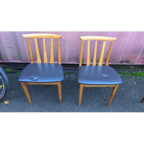 110 - A mid 20th century retro teak extending dining table together with six teak dining chairs, the table... 