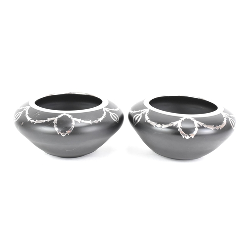 129 - A pair of Art Deco onyx glass bowls, each of baluster form and overlay with silver in the Adams styl... 