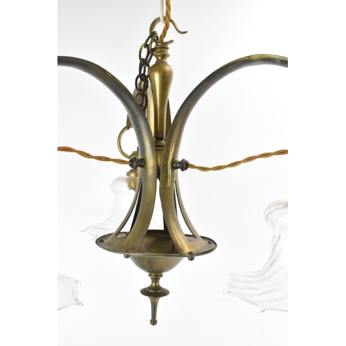 144 - An Arts & Crafts brass chandelier, having three branches with scrolled arms, with suspending spiral ... 