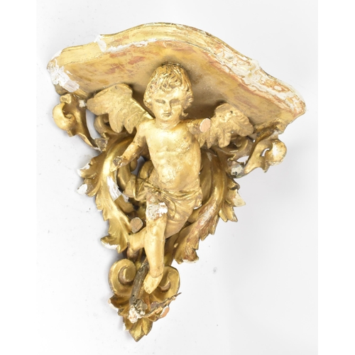 167 - A 19th century gilt gesso corner wall hanging bracket, in the form of a winged cherub among a floral... 