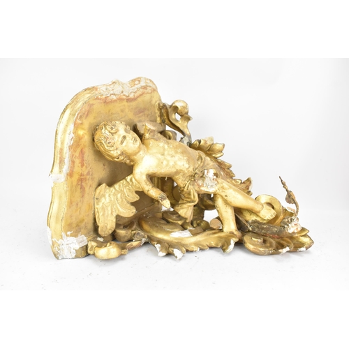 167 - A 19th century gilt gesso corner wall hanging bracket, in the form of a winged cherub among a floral... 