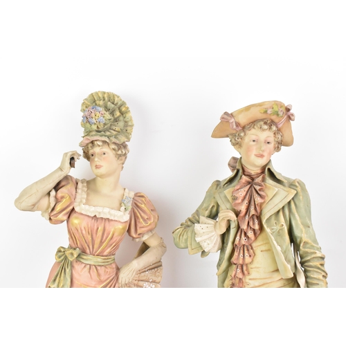 178 - A pair of early 20th century Royal Dux large figures, each in 18th century dress and raised on raise... 