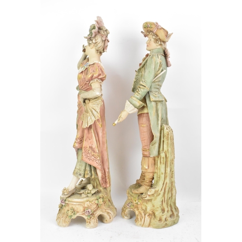 178 - A pair of early 20th century Royal Dux large figures, each in 18th century dress and raised on raise... 