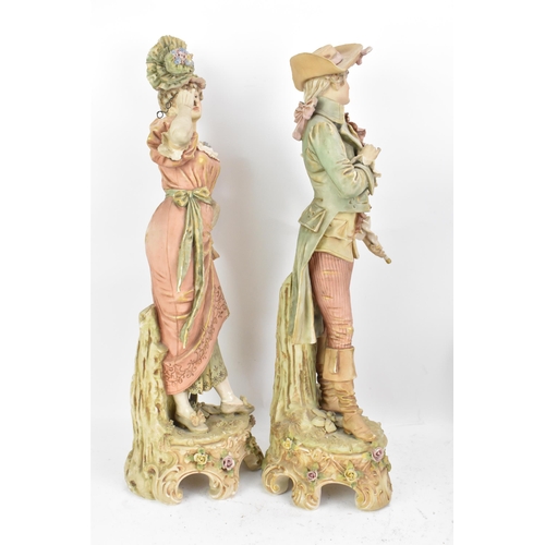 178 - A pair of early 20th century Royal Dux large figures, each in 18th century dress and raised on raise... 