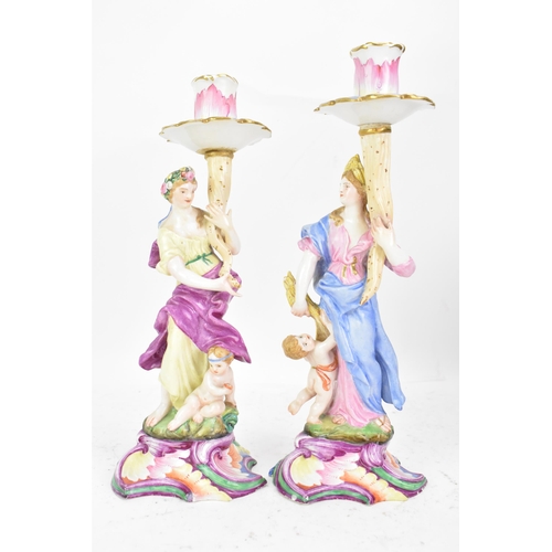 181 - Two 19th century Capodimonte porcelain figural candlesticks, each painted in polychrome enamels, eac... 