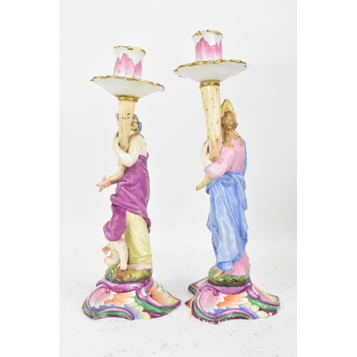 181 - Two 19th century Capodimonte porcelain figural candlesticks, each painted in polychrome enamels, eac... 