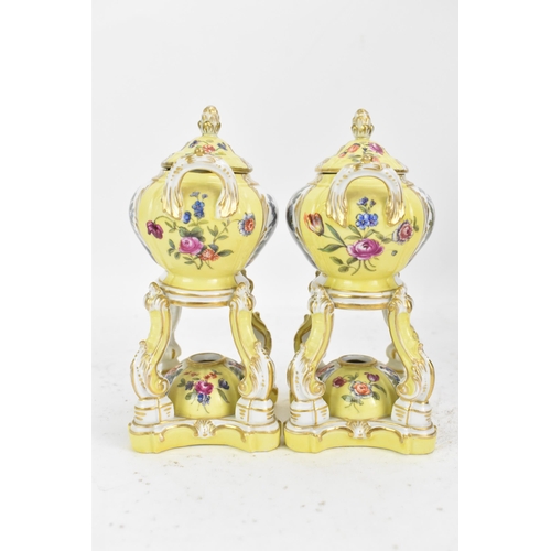 182 - A pair of KPM Berlin porcelain pot pourri's or pastille burners, the twin handled bowls on scroll su... 