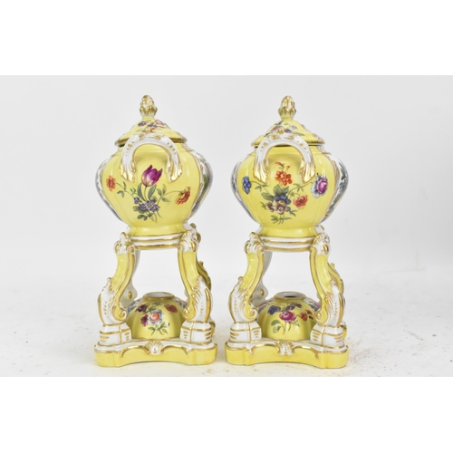 182 - A pair of KPM Berlin porcelain pot pourri's or pastille burners, the twin handled bowls on scroll su... 