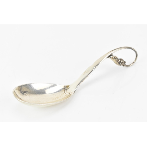 2 - A 1930's Georg Jensen 925 silver caddy spoon, import marks for London 1930, having a stylised scroll... 