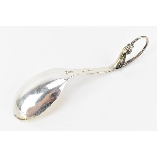 2 - A 1930's Georg Jensen 925 silver caddy spoon, import marks for London 1930, having a stylised scroll... 