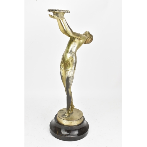 23 - An Art Deco silvered spelter table figural table lamp, in the form of a nude posed lady, mounted on ... 