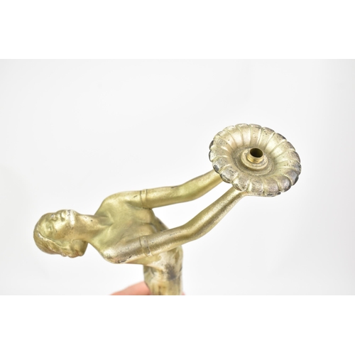 23 - An Art Deco silvered spelter table figural table lamp, in the form of a nude posed lady, mounted on ... 