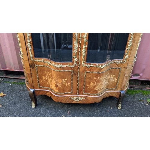 236 - A 19th century French Louis XV style kingwood vitrine display cabinet, serpentine fronted with twin ... 