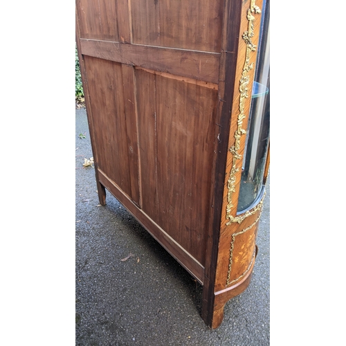 236 - A 19th century French Louis XV style kingwood vitrine display cabinet, serpentine fronted with twin ... 