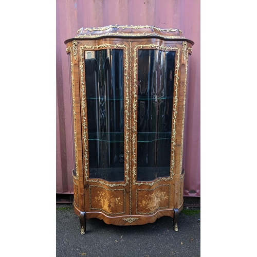 236 - A 19th century French Louis XV style kingwood vitrine display cabinet, serpentine fronted with twin ... 