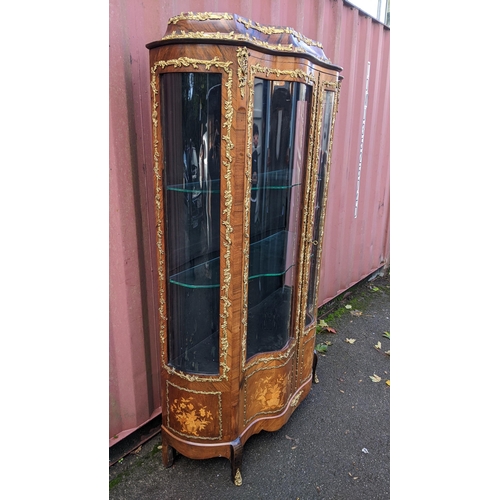 236 - A 19th century French Louis XV style kingwood vitrine display cabinet, serpentine fronted with twin ... 