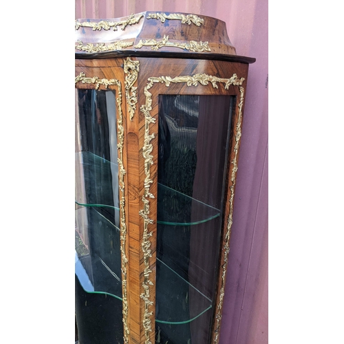 236 - A 19th century French Louis XV style kingwood vitrine display cabinet, serpentine fronted with twin ... 