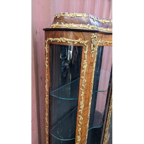 236 - A 19th century French Louis XV style kingwood vitrine display cabinet, serpentine fronted with twin ... 