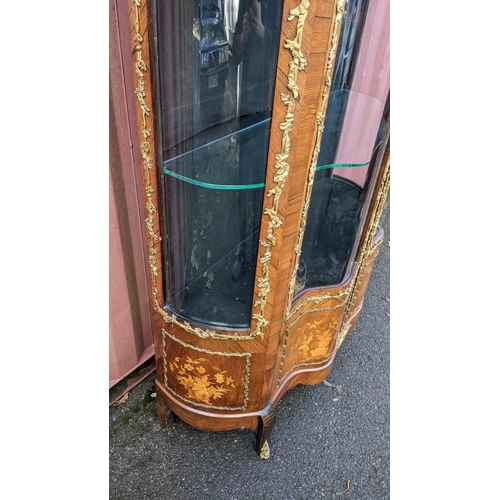 236 - A 19th century French Louis XV style kingwood vitrine display cabinet, serpentine fronted with twin ... 