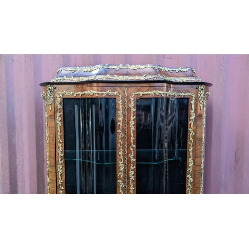 236 - A 19th century French Louis XV style kingwood vitrine display cabinet, serpentine fronted with twin ... 