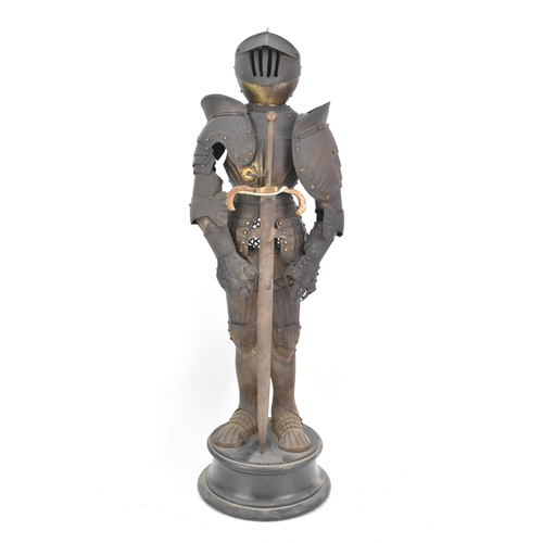 247 - A late 19th century small scale model of an articulated suit of armour, standing with a sword and mo... 