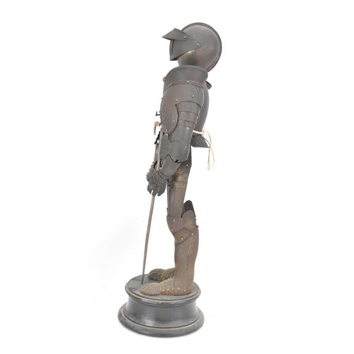 247 - A late 19th century small scale model of an articulated suit of armour, standing with a sword and mo... 