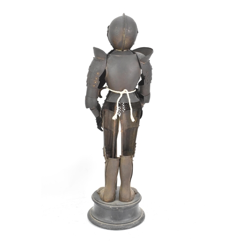 247 - A late 19th century small scale model of an articulated suit of armour, standing with a sword and mo... 