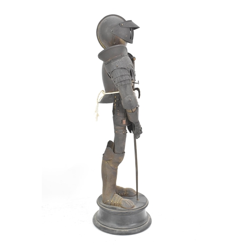 247 - A late 19th century small scale model of an articulated suit of armour, standing with a sword and mo... 