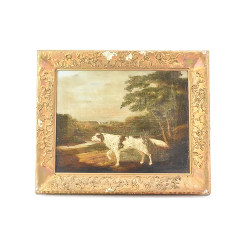 250 - A 19th century oil on canvas depicting a spaniel dog in a wooded landscape scene with buildings to t... 