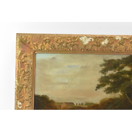 250 - A 19th century oil on canvas depicting a spaniel dog in a wooded landscape scene with buildings to t... 