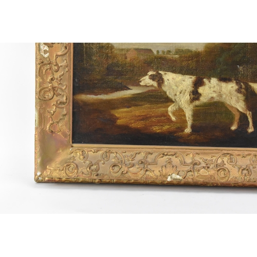 250 - A 19th century oil on canvas depicting a spaniel dog in a wooded landscape scene with buildings to t... 