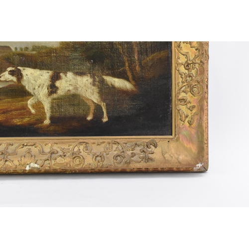 250 - A 19th century oil on canvas depicting a spaniel dog in a wooded landscape scene with buildings to t... 