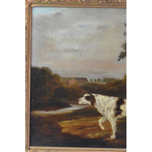 250 - A 19th century oil on canvas depicting a spaniel dog in a wooded landscape scene with buildings to t... 