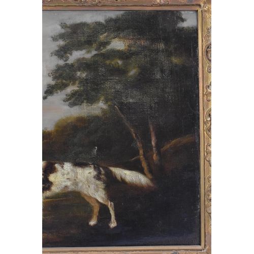 250 - A 19th century oil on canvas depicting a spaniel dog in a wooded landscape scene with buildings to t... 