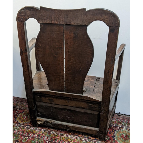 252 - An early 18th century Welsh oak armchair having a curved top rail, vase splat back and the seat with... 