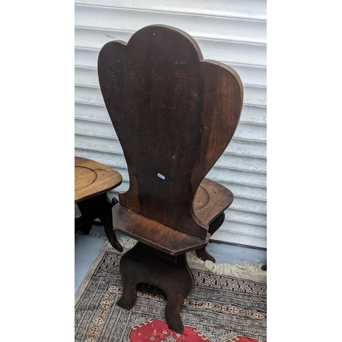 263 - A set of four George II mahogany hall chairs, each of sgabello form with escutcheon shaped backs, ci... 