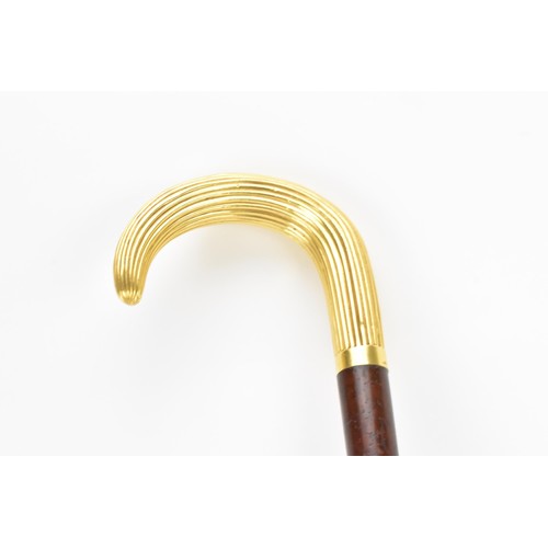 243 - An early 20th century gold plated handled walking stick, the handle of reeded form and stamped G.O.P... 